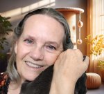 Portrait of author Deborah Sarty hugging a cat